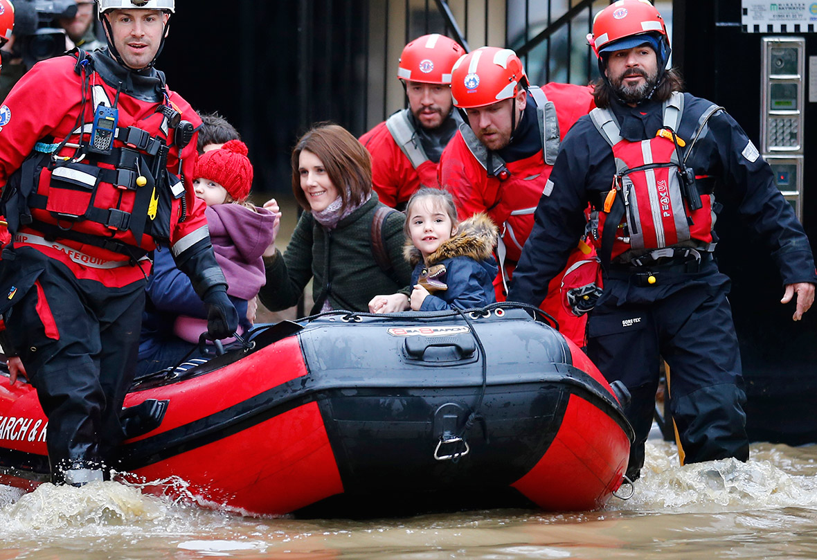A family are rescued from their flooded home by a mountain rescue team in Y...