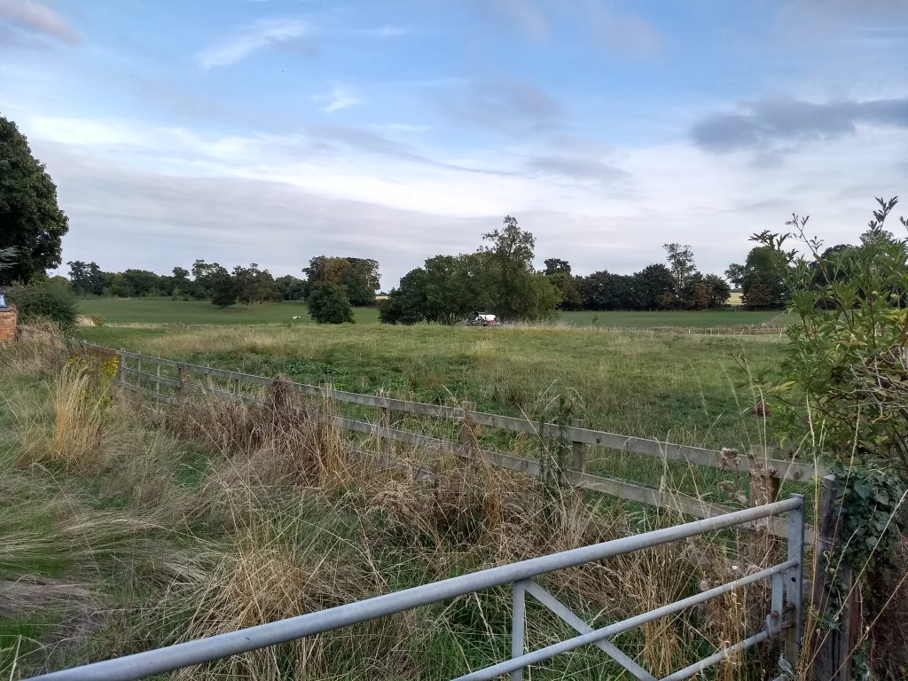 Co-Op farmer sprays his grass field