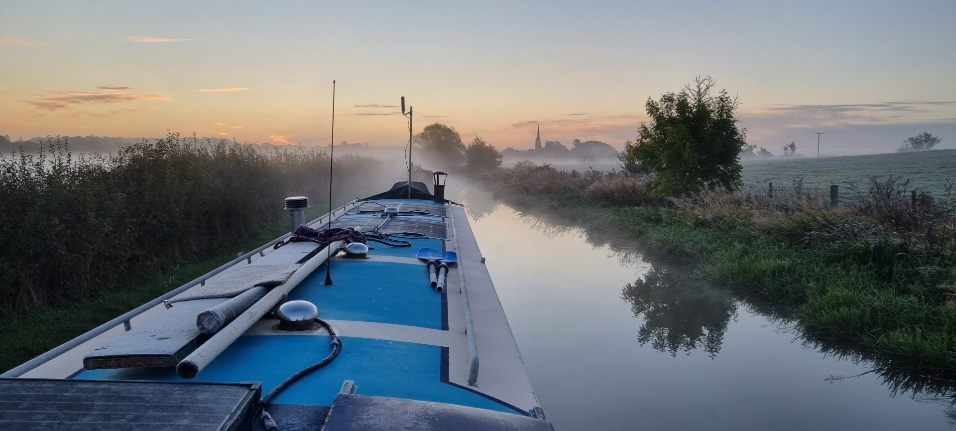 A view of Kings Sutton in the mist from the Oxford Canal.